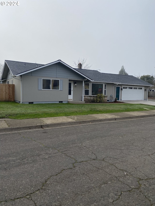 single story home featuring a front lawn and a garage