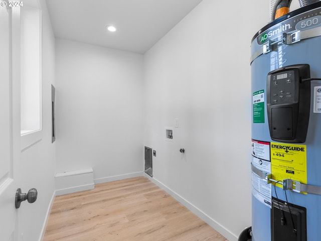 laundry area with water heater, washer hookup, electric dryer hookup, and light hardwood / wood-style floors