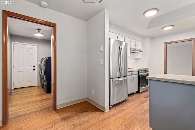 kitchen featuring separate washer and dryer, appliances with stainless steel finishes, white cabinets, and light hardwood / wood-style floors