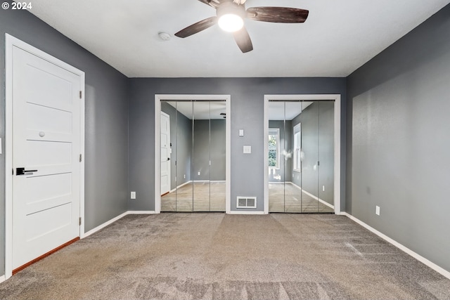 spare room with ceiling fan and light carpet