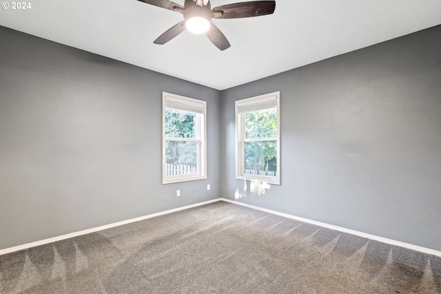 carpeted empty room featuring ceiling fan