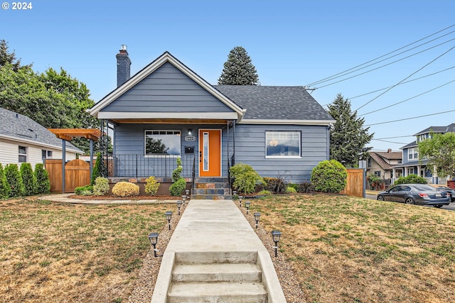 bungalow-style home featuring a front yard