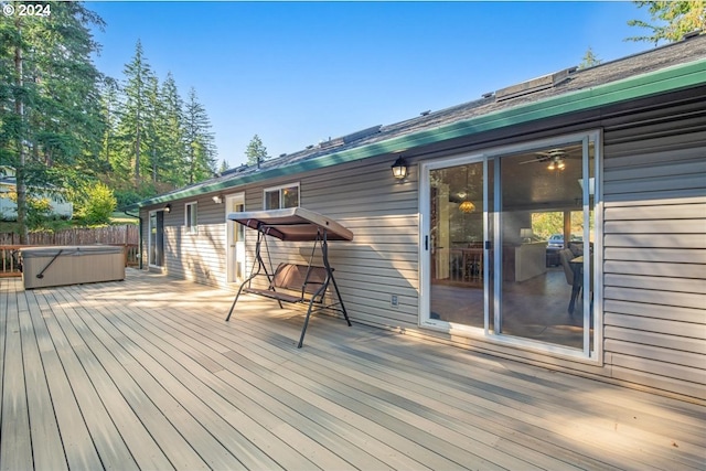 wooden deck with a hot tub