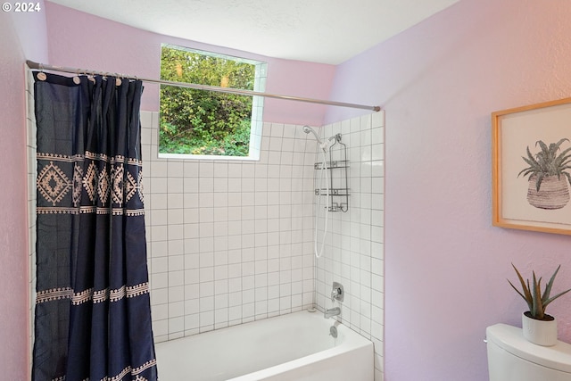 bathroom featuring toilet, a textured ceiling, and shower / tub combo with curtain