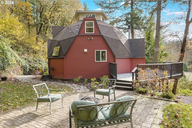 rear view of house with a deck and a patio