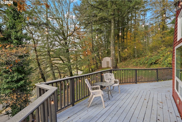 wooden deck featuring a storage shed