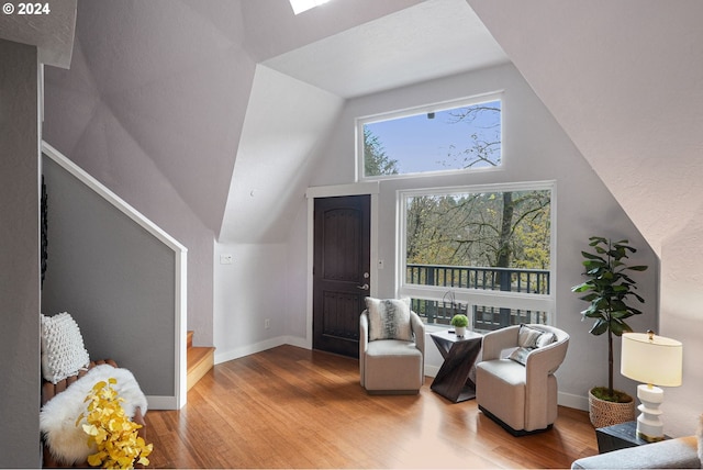 7184 Battle Creek Rd, Salem, OR 97317 - living area with wood finished floors, stairs, vaulted ceiling, and baseboards