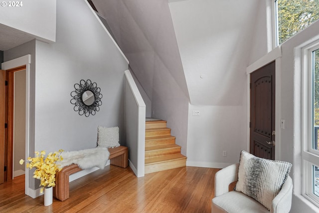 entrance foyer with lofted ceiling and light wood-type flooring