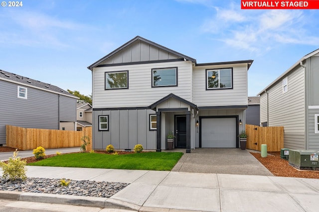 view of front of home with a garage and a front lawn