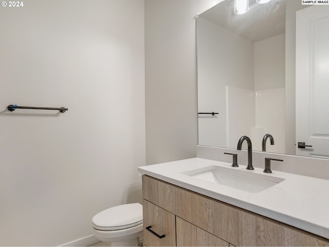 bathroom with vanity and toilet