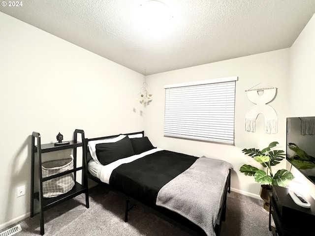 bedroom featuring carpet and a textured ceiling