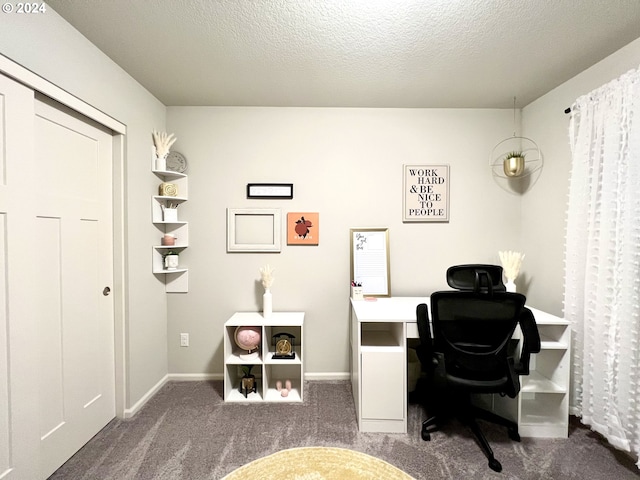 office area with dark carpet and a textured ceiling