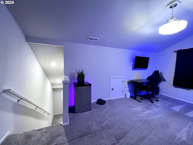 carpeted home office featuring vaulted ceiling