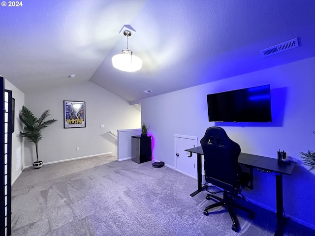 carpeted office space with vaulted ceiling