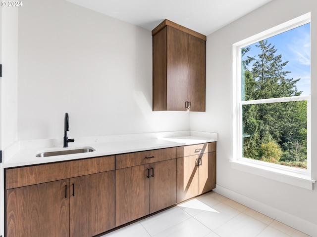 interior space featuring tile patterned flooring, vanity, and baseboards