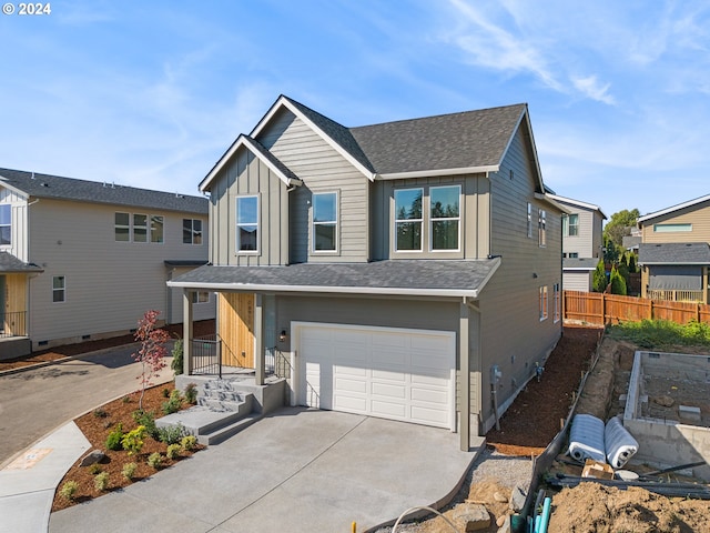 view of front of home with fence, a garage, concrete driveway, board and batten siding, and a shingled roof