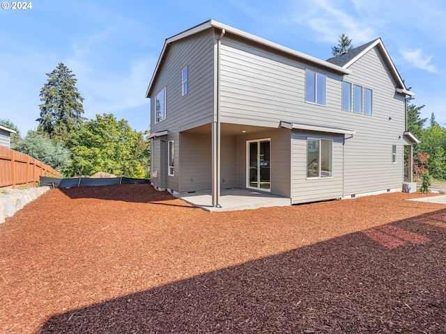 back of house with crawl space, fence, and a patio