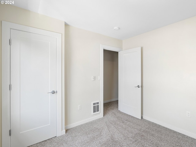 unfurnished bedroom featuring light colored carpet