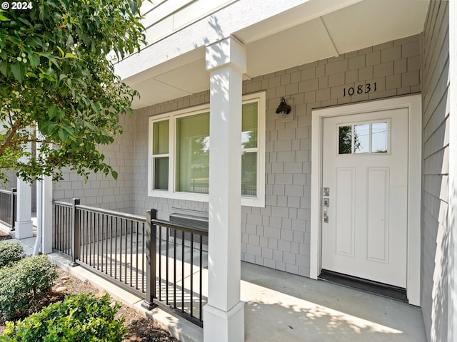 view of exterior entry with a porch