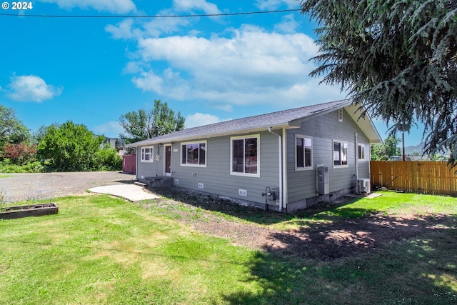 back of house with a yard and cooling unit