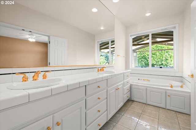 bathroom with ceiling fan, tile patterned floors, a bath, and vanity