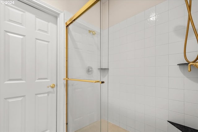 bathroom featuring a shower with door