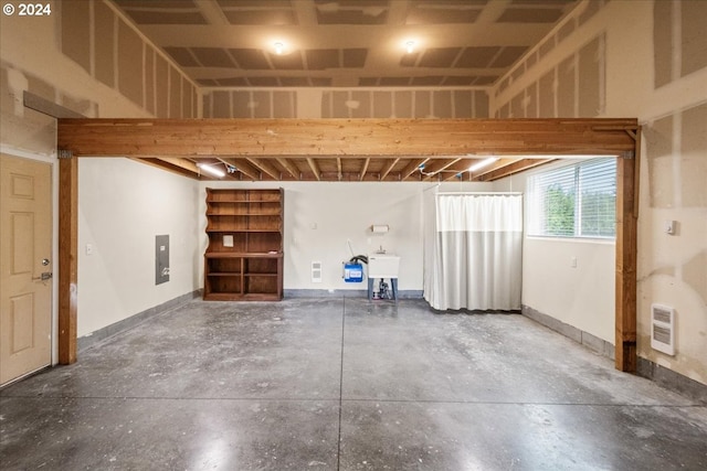 basement with heating unit and sink