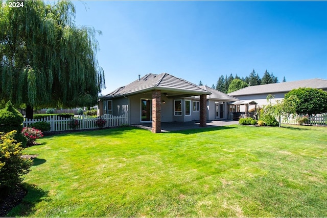 back of property featuring a gazebo, a lawn, and a patio