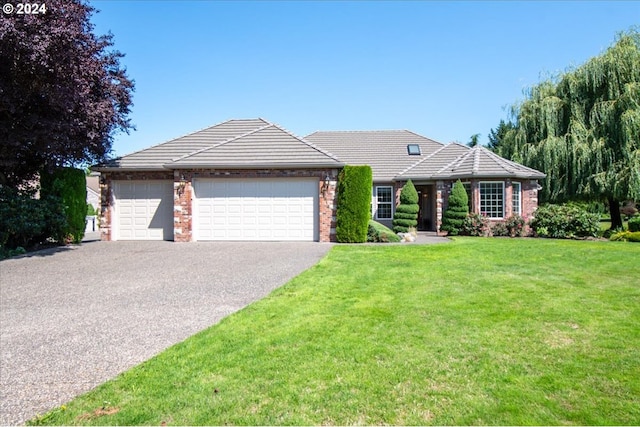 single story home with a front lawn and a garage