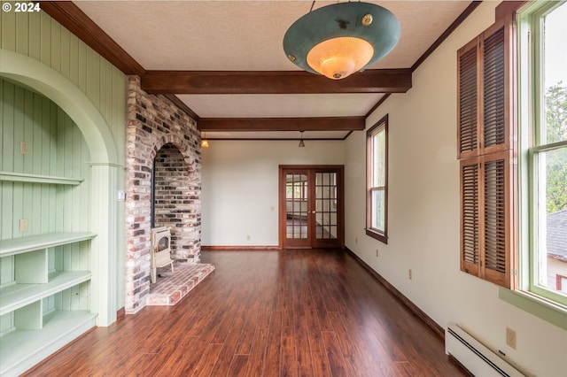 unfurnished living room featuring a wood stove, french doors, a baseboard heating unit, crown molding, and dark hardwood / wood-style floors