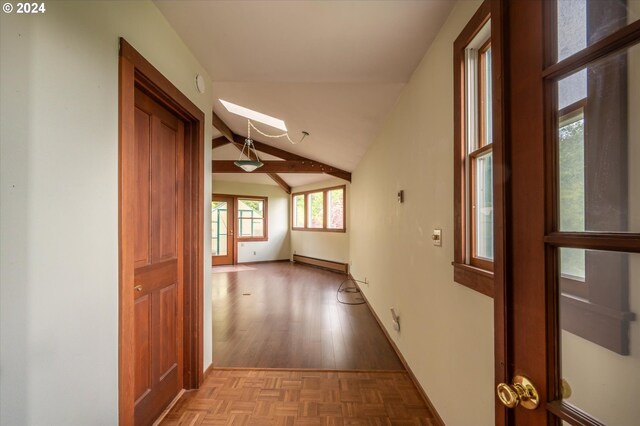 corridor with baseboard heating, vaulted ceiling with beams, and light hardwood / wood-style floors