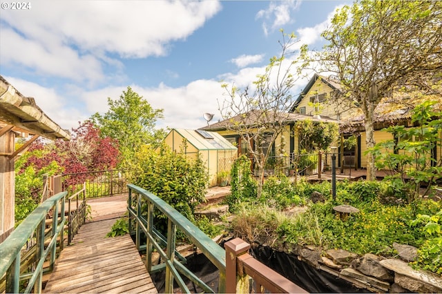 exterior space featuring a wooden deck and a storage shed