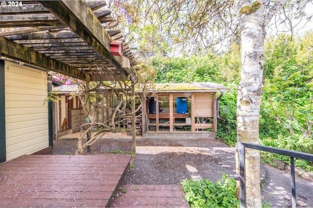 exterior space with a pergola and a wooden deck