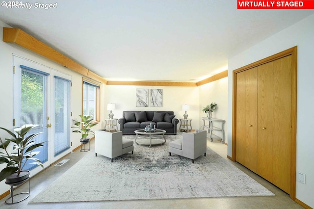 living room featuring baseboards and visible vents