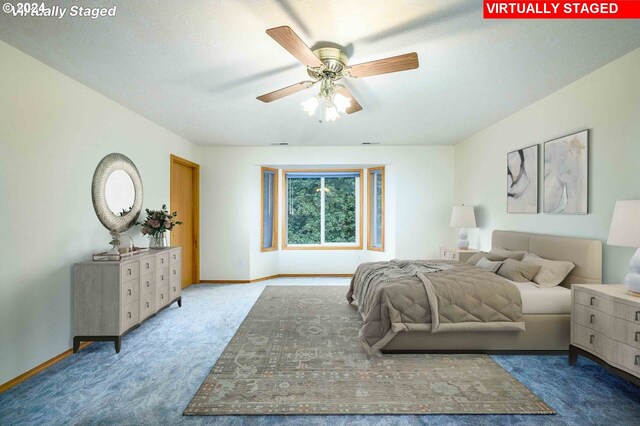 bedroom featuring ceiling fan and carpet