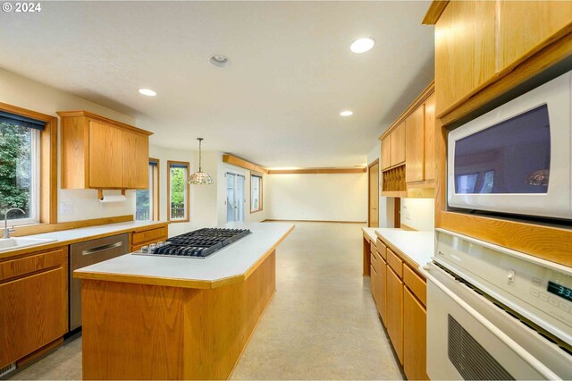 kitchen featuring plenty of natural light, a center island, stainless steel appliances, and pendant lighting