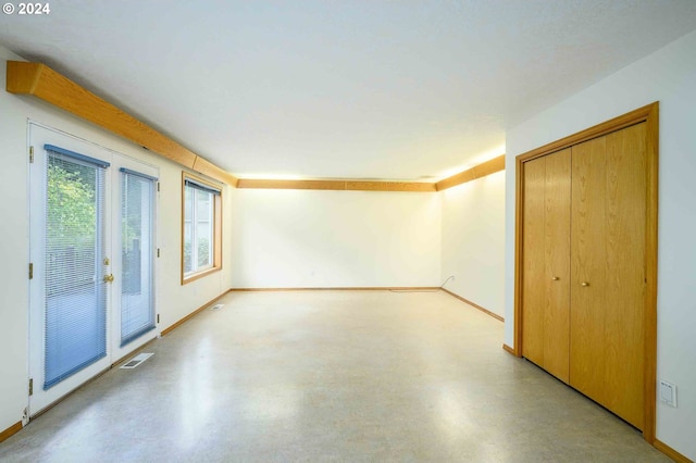 unfurnished room with visible vents and baseboards