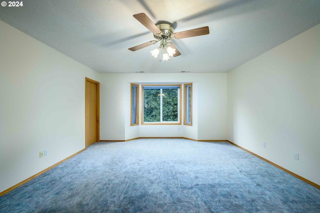 carpeted empty room with a textured ceiling and ceiling fan