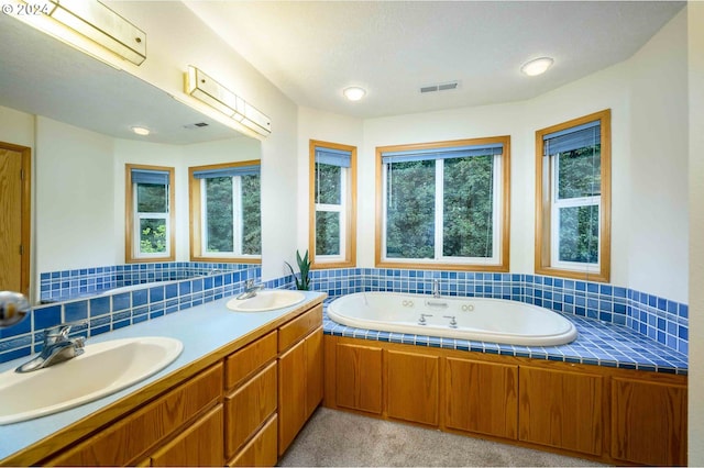 bathroom featuring a sink, visible vents, and a healthy amount of sunlight