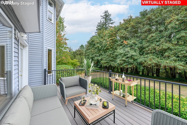 deck featuring a lawn and an outdoor living space