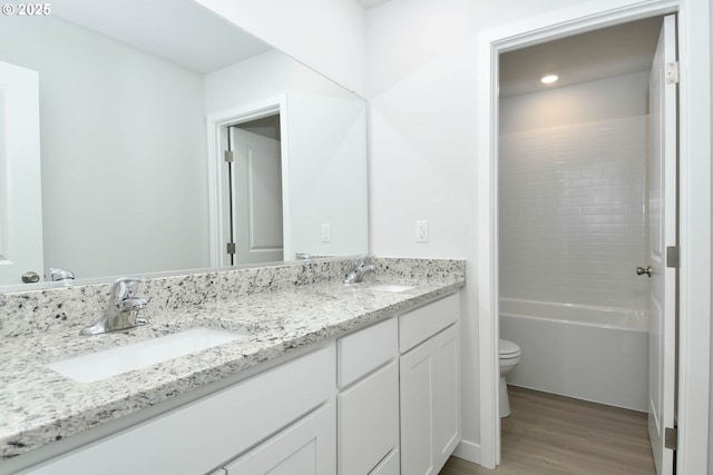 964 NE 14th St, Battle Ground, WA 98604 - bathroom with wood finished floors, toilet, double vanity, and recessed lighting