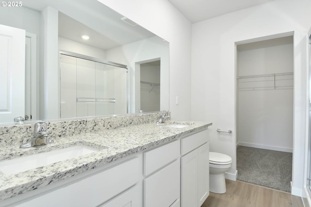 964 NE 14th St, Battle Ground, WA 98604 - full bath with a shower stall, wood finished floors, toilet, double vanity, and a walk in closet