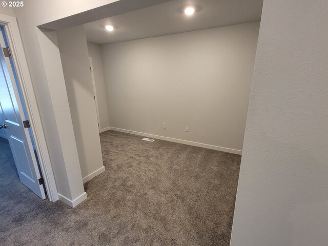 carpeted empty room with visible vents, baseboards, and recessed lighting