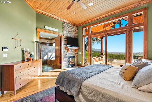 bedroom featuring wooden ceiling, hardwood / wood-style flooring, ornamental molding, access to exterior, and a fireplace