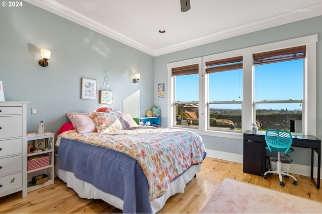 bedroom with ceiling fan, crown molding, and light hardwood / wood-style flooring