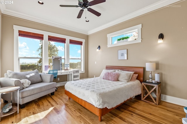 bedroom with ceiling fan, light wood-type flooring, and ornamental molding