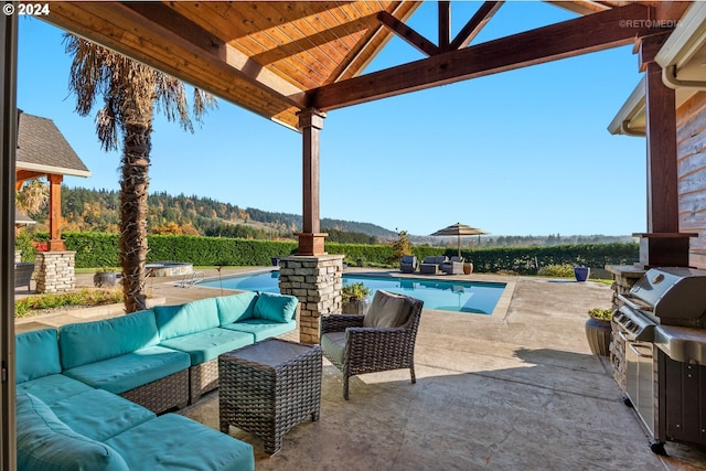 view of patio with a mountain view, a gazebo, an outdoor living space, grilling area, and area for grilling