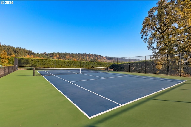 2945 SW Homesteader Rd, West Linn, OR 97068 - view of tennis court featuring fence, community basketball court, and a wooded view