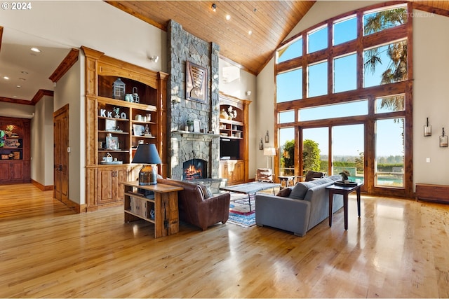 living room featuring high vaulted ceiling, wood ceiling, a healthy amount of sunlight, and light hardwood / wood-style floors