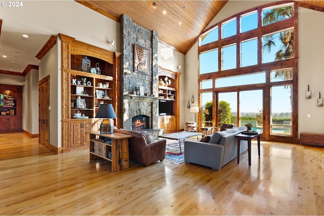2945 SW Homesteader Rd, West Linn, OR 97068 - living area with light wood finished floors, a stone fireplace, baseboards, high vaulted ceiling, and wooden ceiling